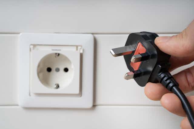 Electric socket with hand holding incompatible plug