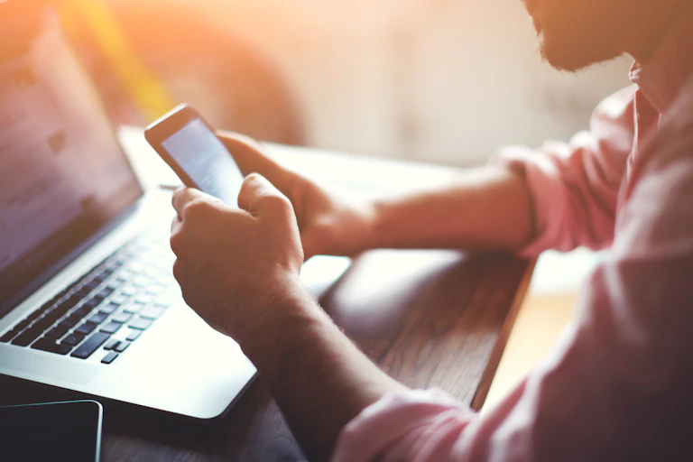 Man with computer and smartphone