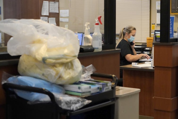 A registered nurse talks on a phone inside the emergency room at Scotland County Hospital in Memphis, Missouri.