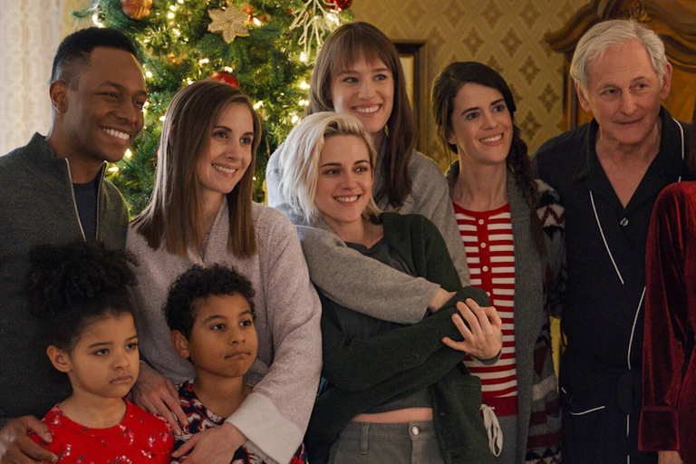 A family standing in front of a Christmas tree