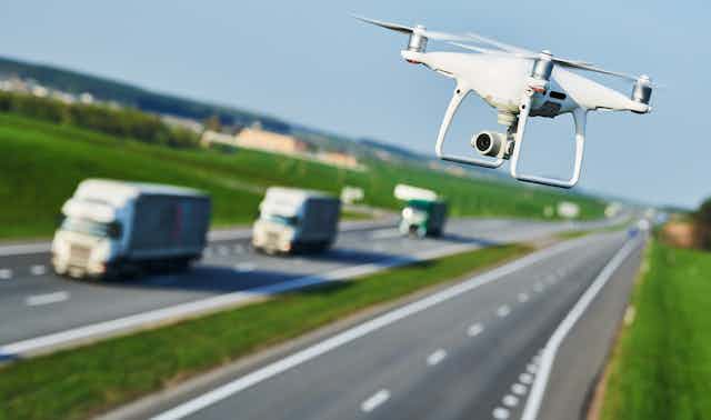 A drone flying above a road.