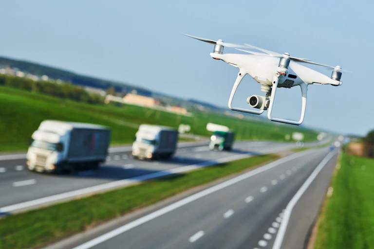A drone flying above a road.