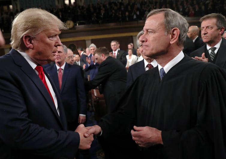 Chief Justice John Roberts and President Trump shake hands at the Feb. 4, 2020 State of the Union address.