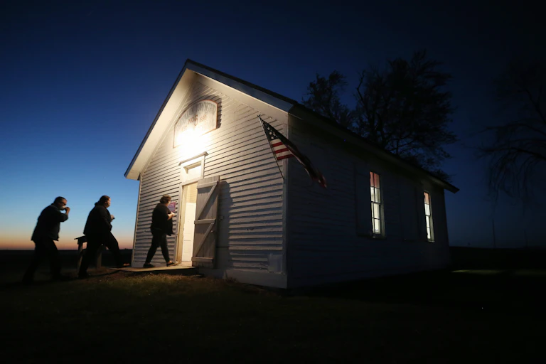 Voters enter a polling place at dusk to cast their ballots at Sherman Township Hall, a former one room schoolhouse, on November 3, 2020 in Zearing, Iowa.