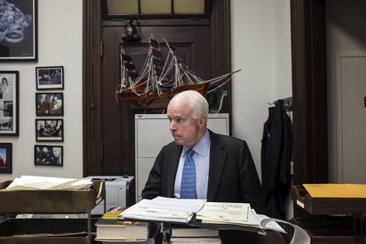 Sen. John McCain at his desk in the Senate.