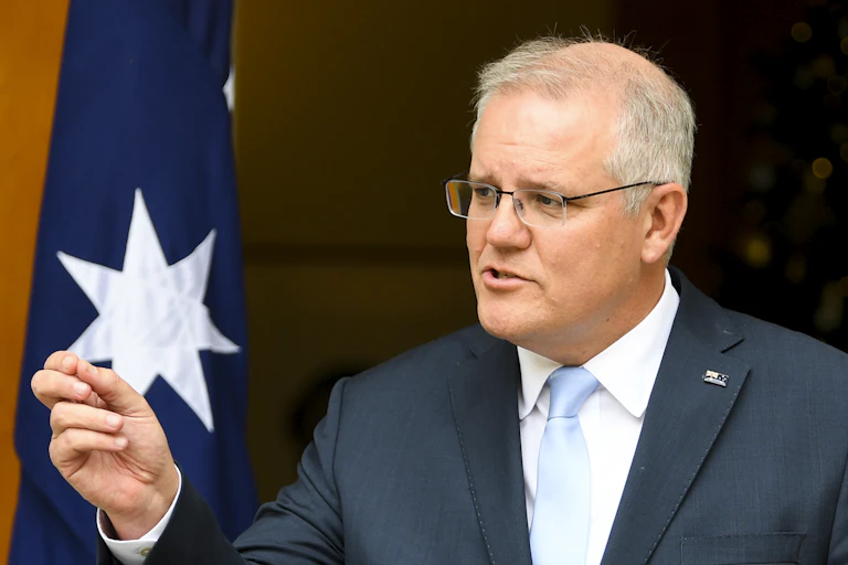 Prime Minister Scott Morrison talking while Aunty Pat Turner watches on