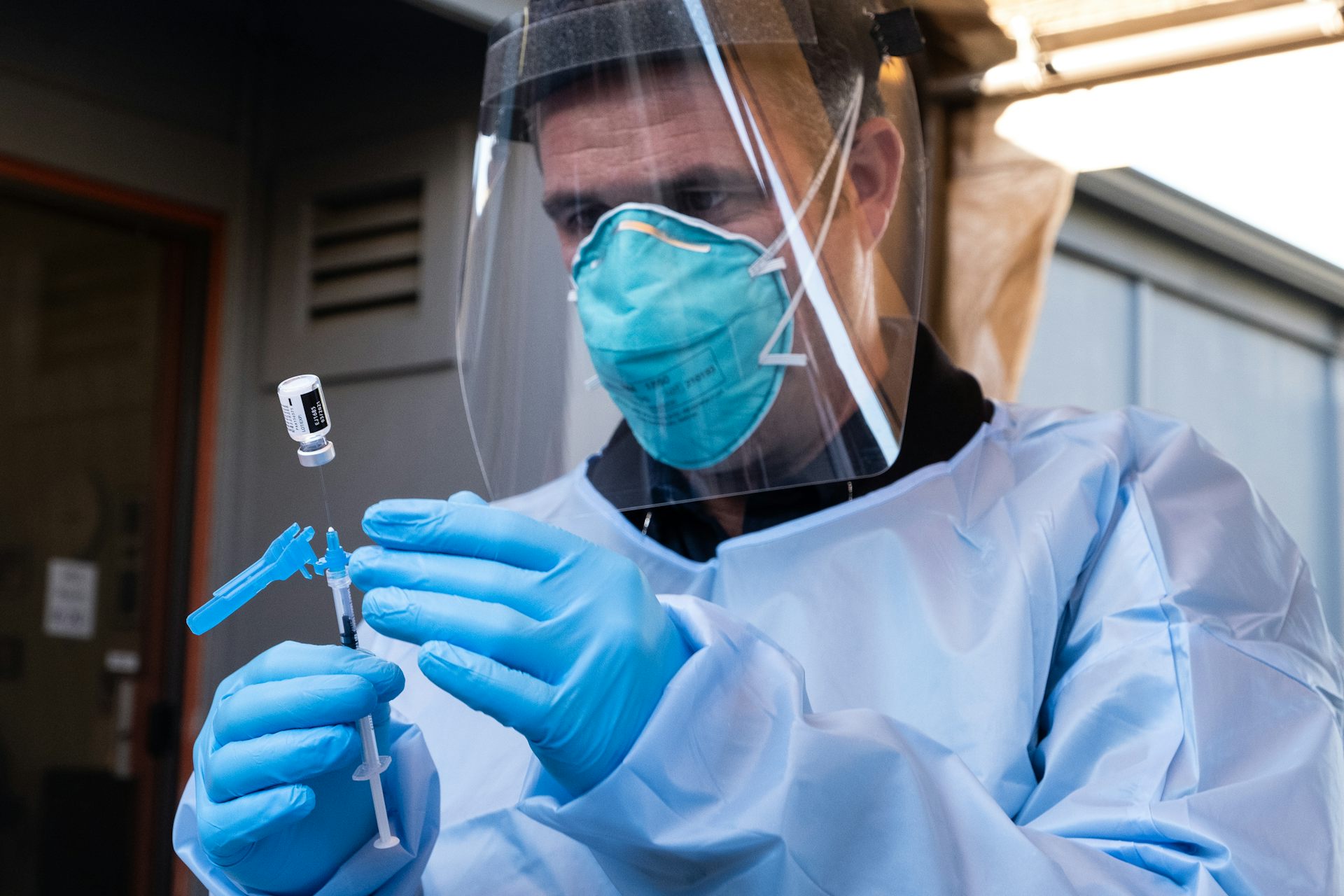 A nurse prepares to administer a dose of the Pfizer vaccine