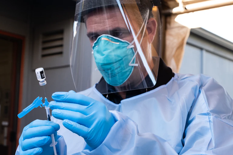 A nurse prepares to administer a dose of the Pfizer vaccine