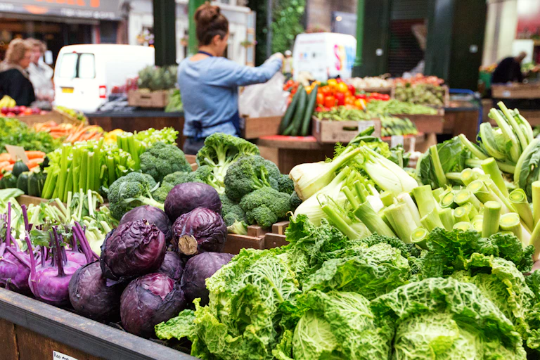 Fresh vegetables in crates at a farmers market, London, UK. Borough market