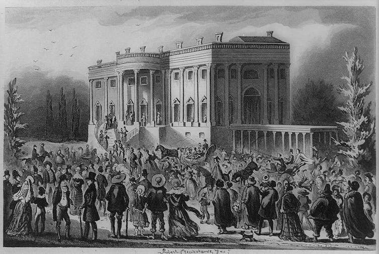 An old picture shows a crowd of people in front of the White House in 1829.