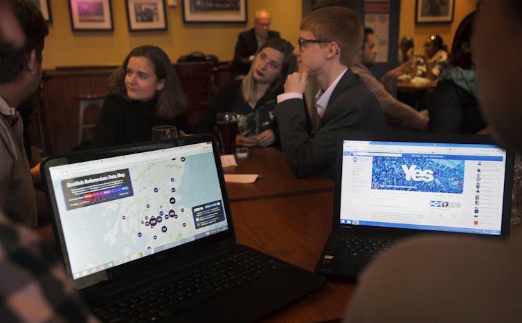 Students look at their laptops.