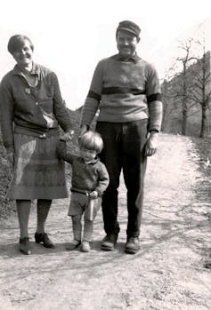 A black and white picture of parents and a child.