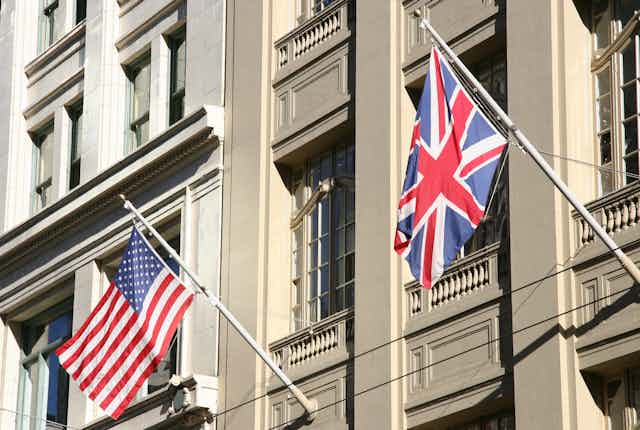 A US and UK flag on the side of a building