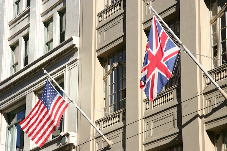 A US and UK flag on the side of a building