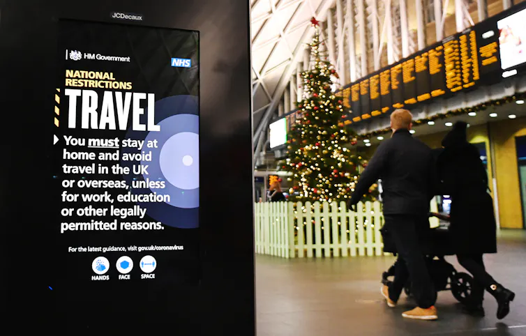 A sign displaying Tier 4 rules at King's Cross station in London