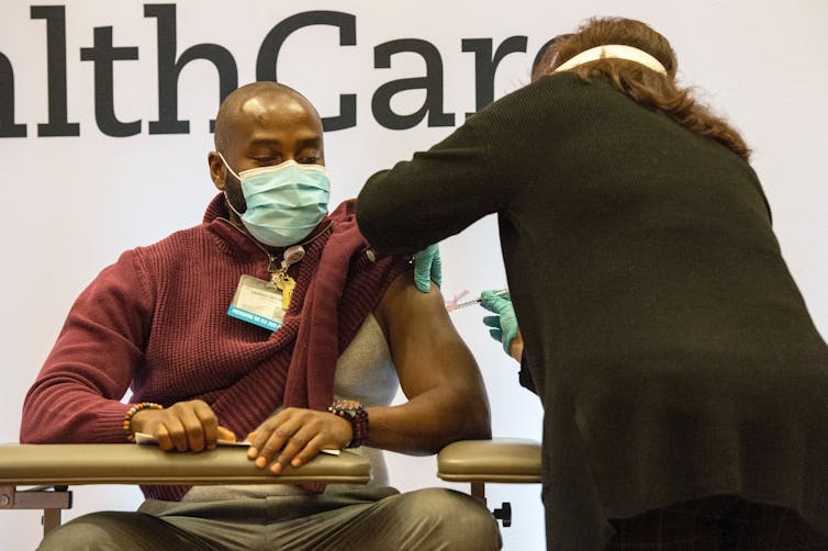 A man receiving the COVID-19 vaccine.