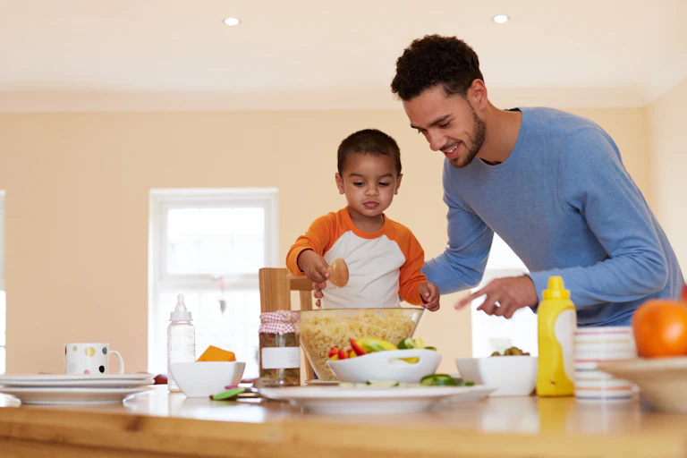 Father and son preparing food