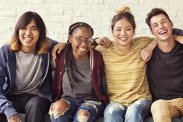 Group of students smiling with arms round eachother