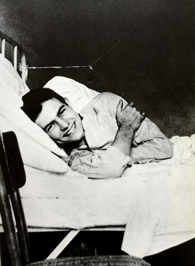 A smiling man in hospital bed.