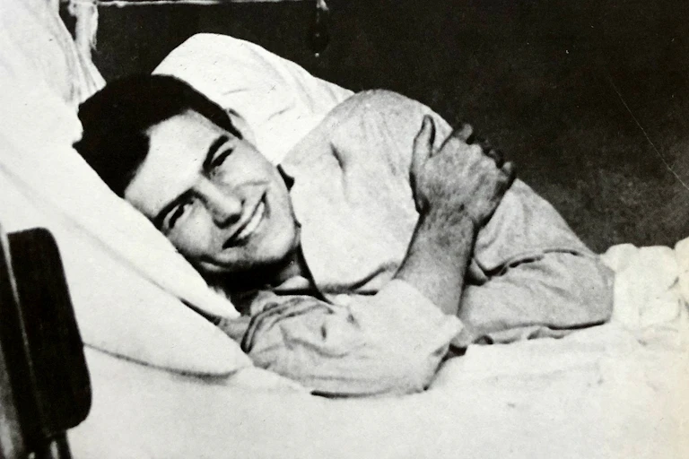 A smiling man in hospital bed.