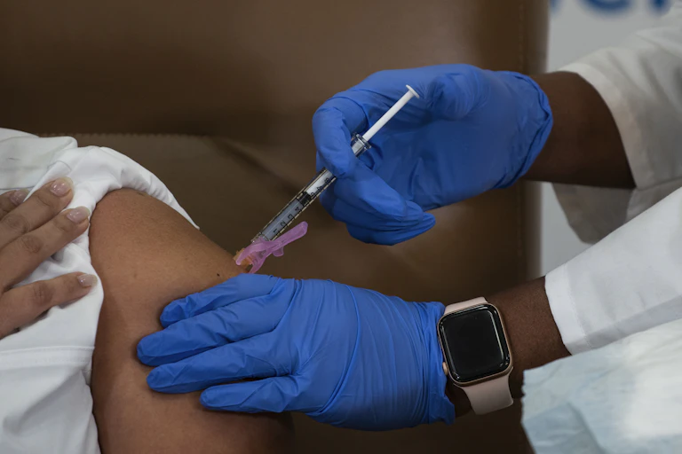 Arlene Ramirez, director of patient care at Long Island Jewish Valley Stream hospital, receives the Moderna COVID-19 vaccine in Valley Stream, N.Y., on Dec. 21, 2020.