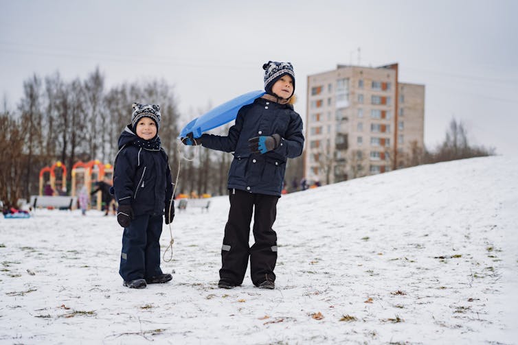 Brothers with a sled.