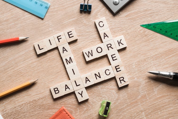 Scrabble tiles spell out linked words 'life', 'work', 'balance', 'family' and 'career'.