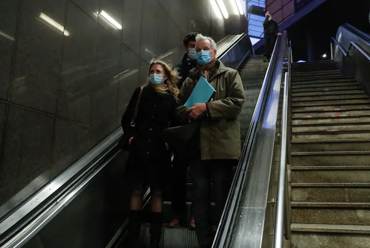 Michel Barnier and his colleagues ride an escalator in Brussels.