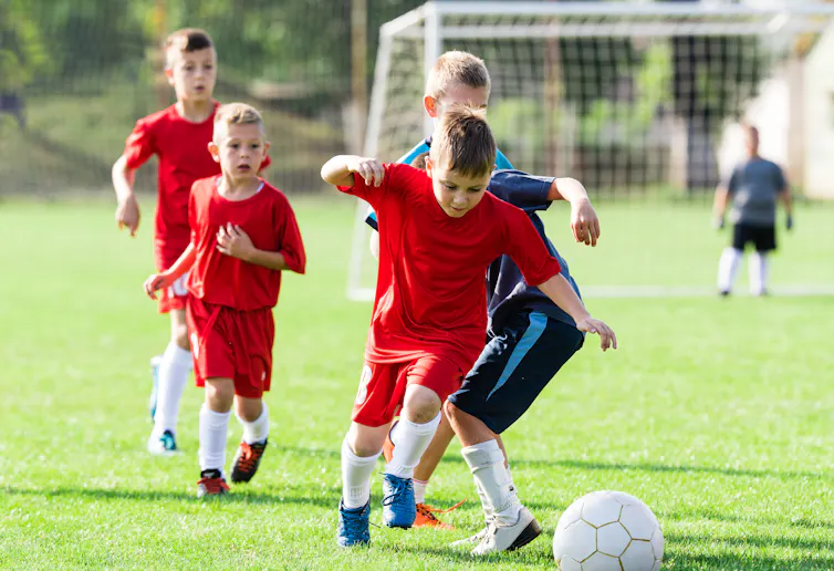 Young boys playing football.