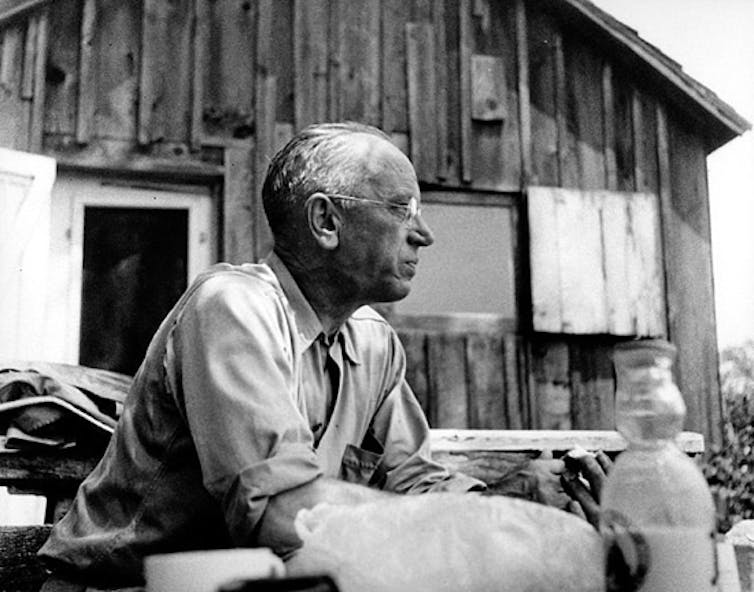 Aldo Leopold seated outdoors