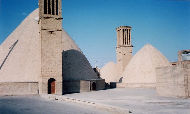 Large double-domed stone structures with windcatcher towers.