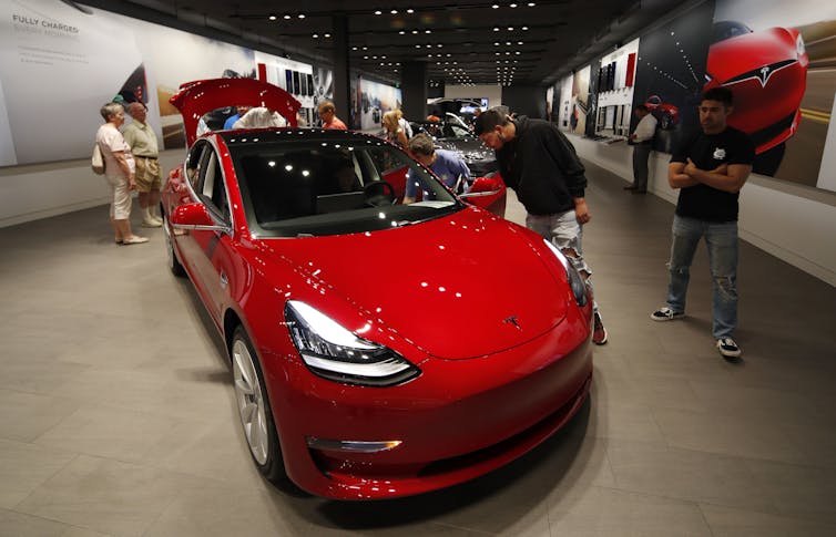 People in a Tesla showroom