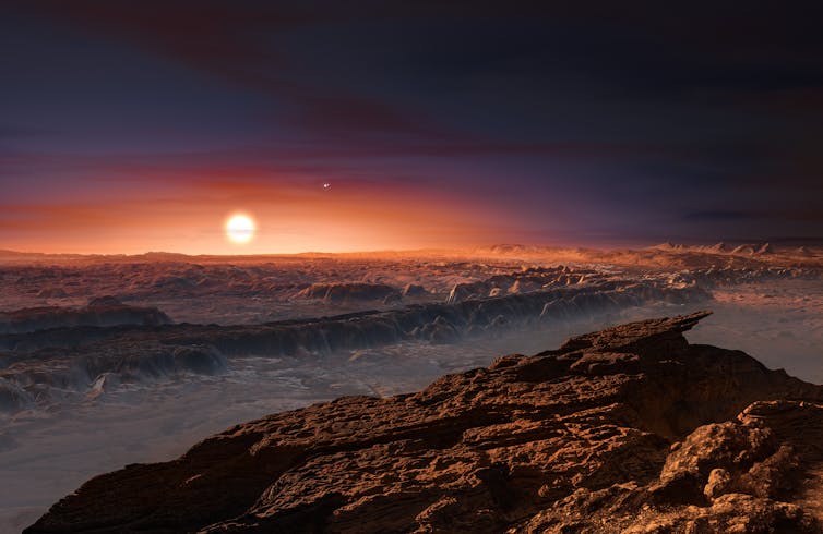 Sun rises over rocky alien landscape.