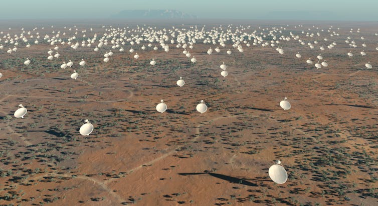 Hundreds of large satellite dishes in a desert.