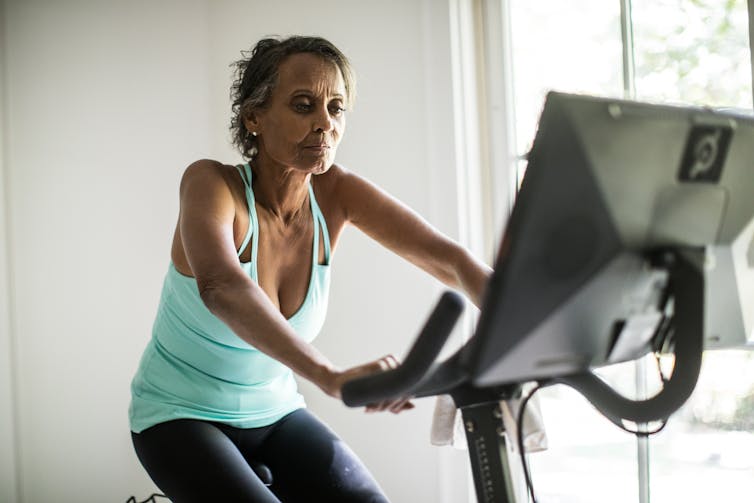 Old woman on an exercise bike