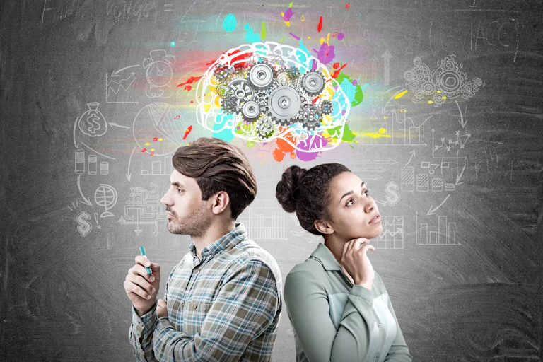 A man and a woman standing under an illustration of a brain with cogs