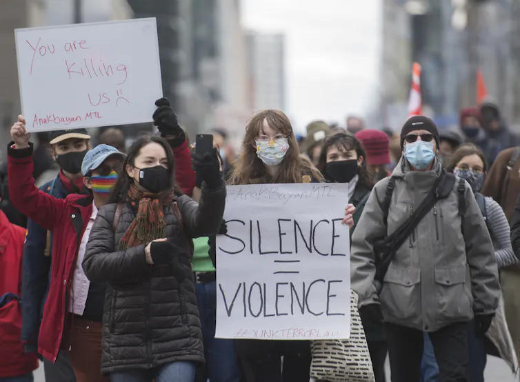 People wearing masks march in a climate protest.