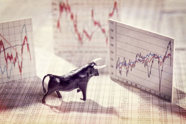 Small bull figurine among various printed charts.