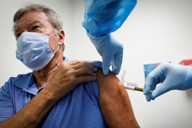 A man receiving a COVID-19 vaccine in the UK