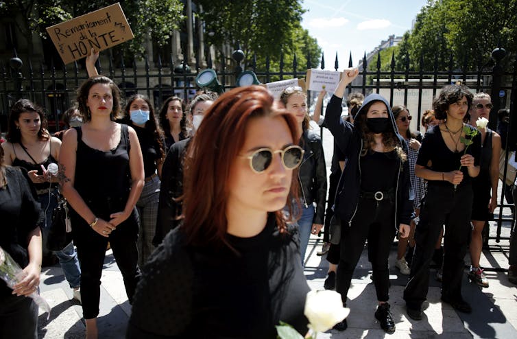 Women dressed in black protest in Paris