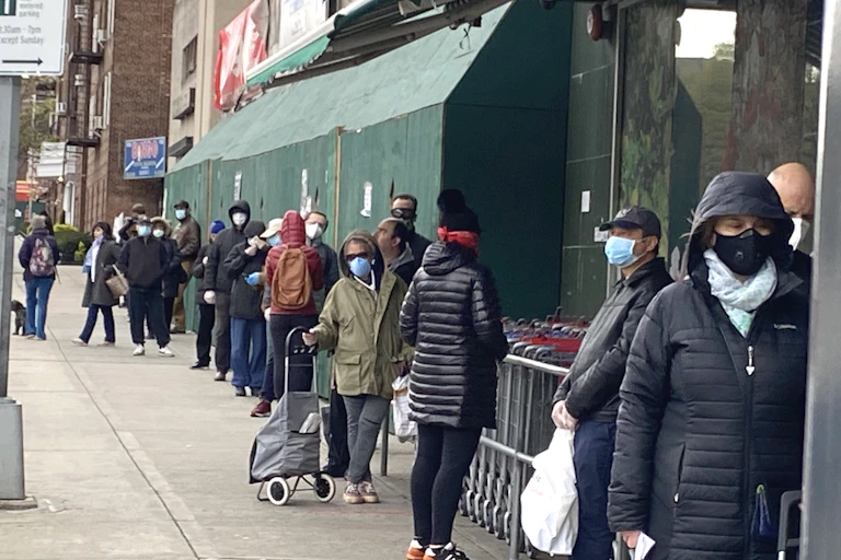 Long line of shoppers waiting to get into Grocery Store, Soci