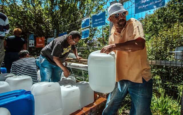 People fill water containers in Cape Town during the drought.