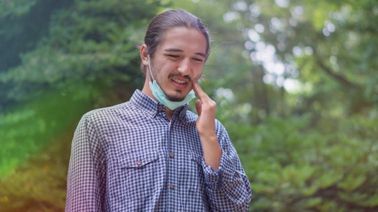 A man suffering from a severe toothache.