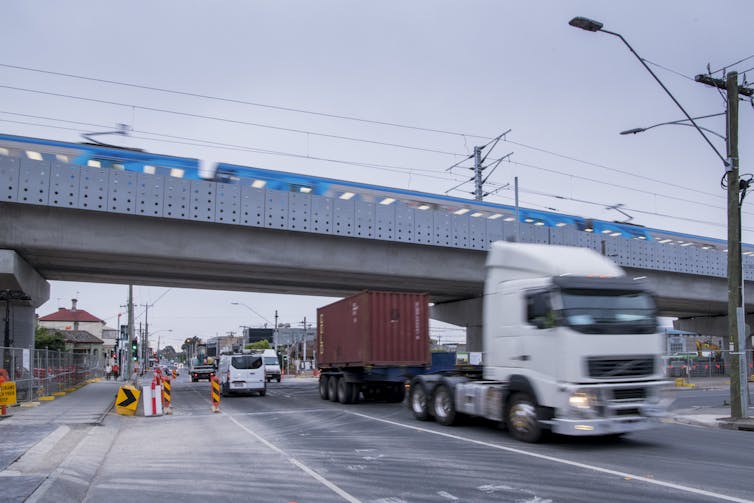 traffic flows under a rail overpass