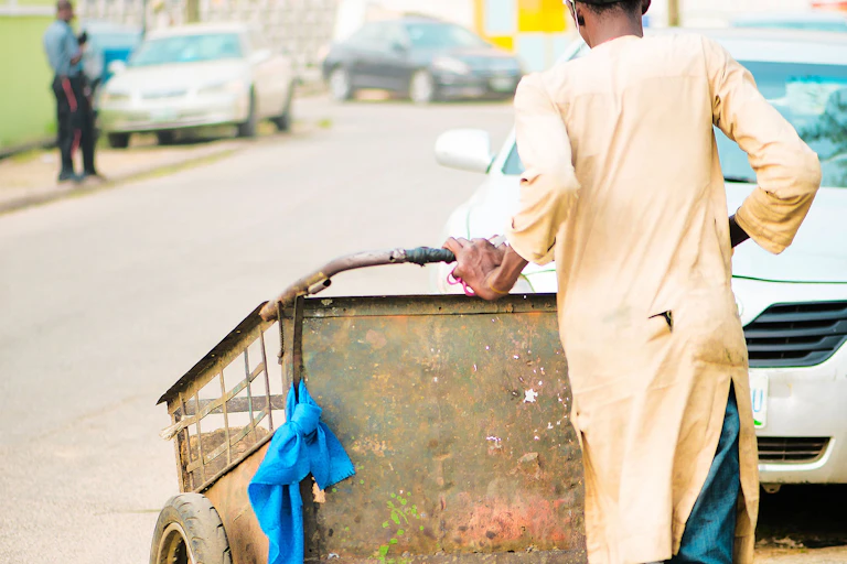 Man pushing a waste cart