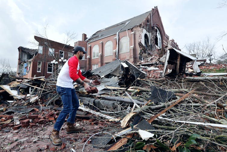 Sumant Joshi helps to clean up rubble at the East End United Methodist Church after it was heavily damaged by storms in Nashville.