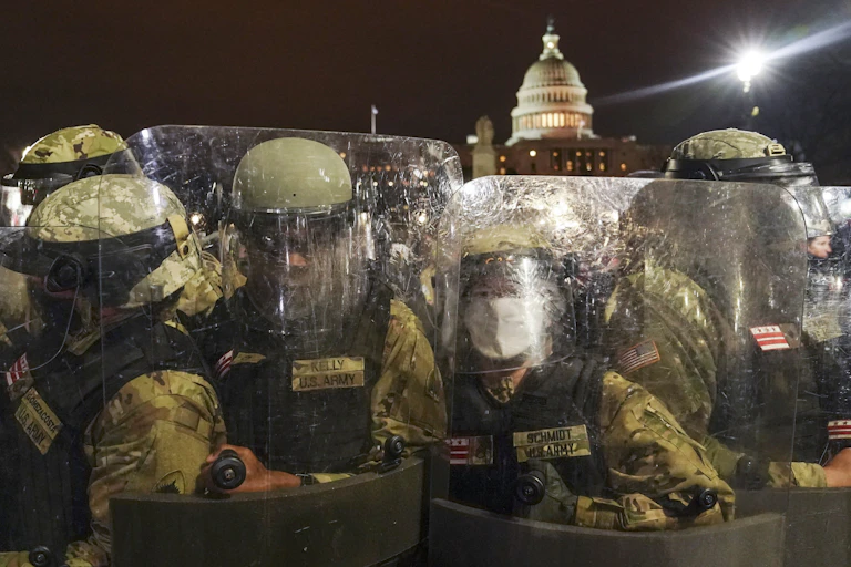 Police in riot gear stand outside the U.S. Capitol