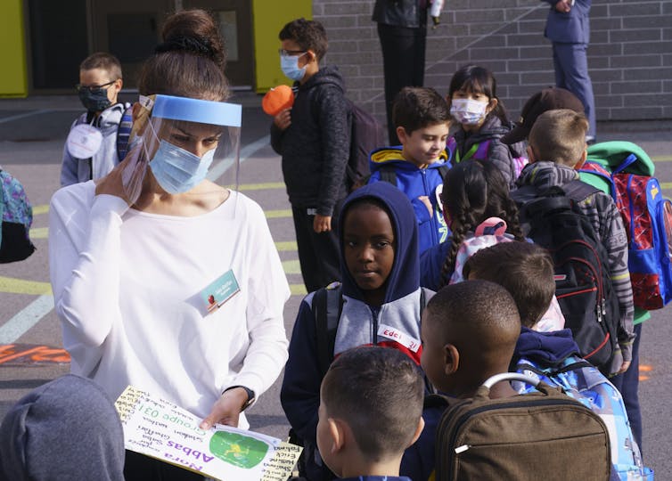 A teacher in a face shield.