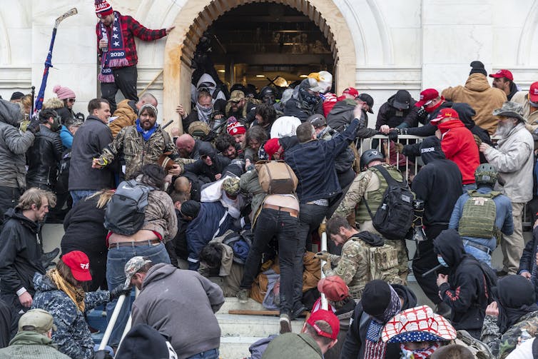 Rioters clash with police trying to enter Capitol building through the front doors.