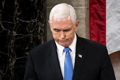 Pence looks down.